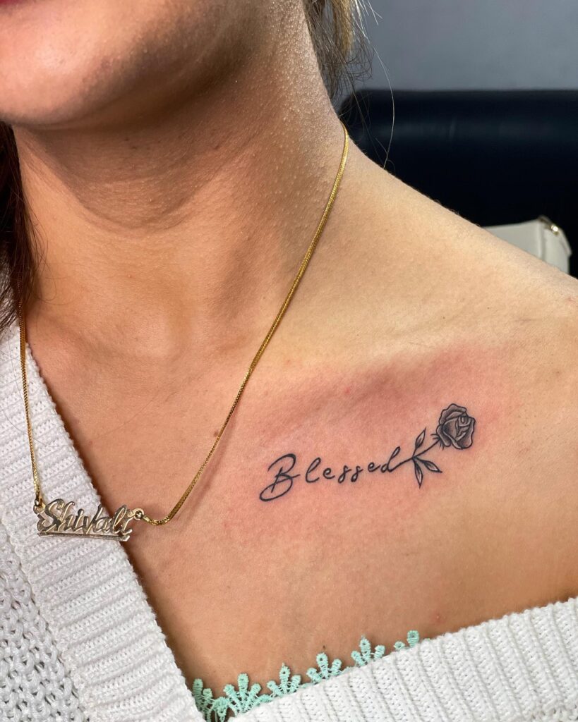 Rose-adorned elegance: 'blessed' theme collarbone tattoo