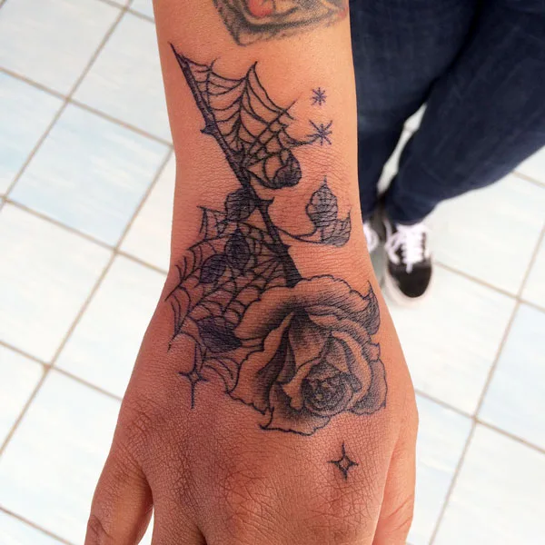 Rose and spider web tattoo