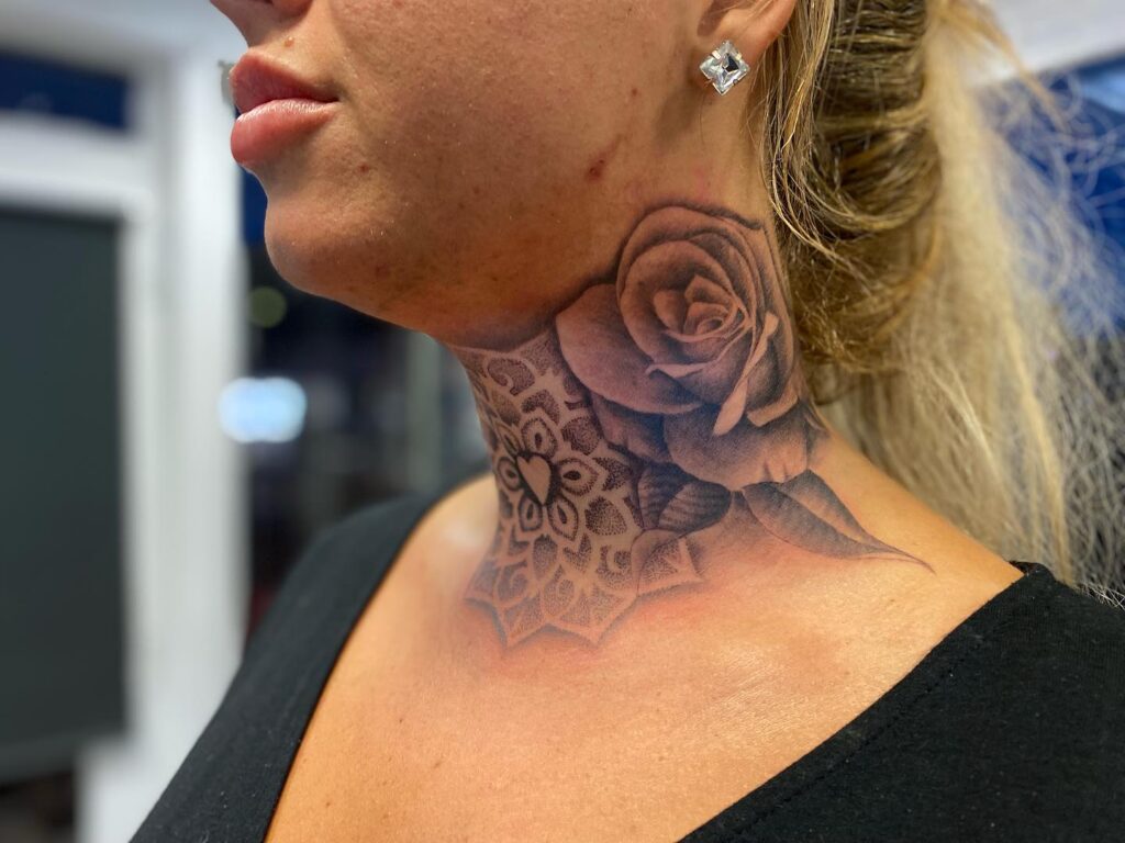 Rose mandala embrace intricate neck tattoo with a mandala of roses
