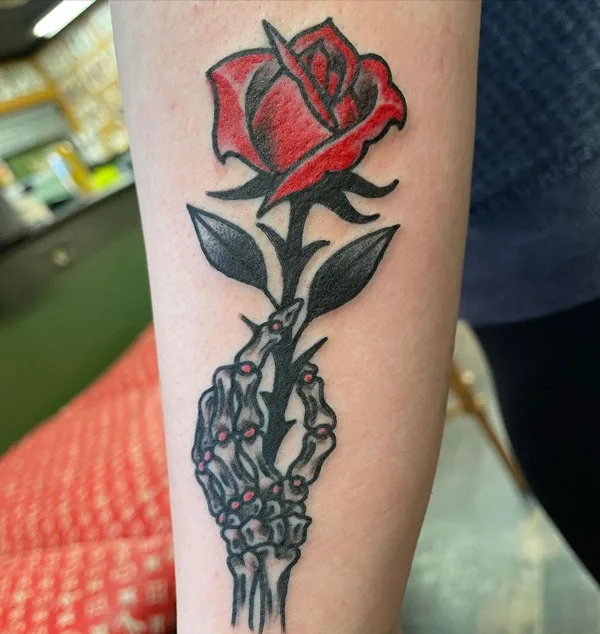 Rose skeleton hand tattoo