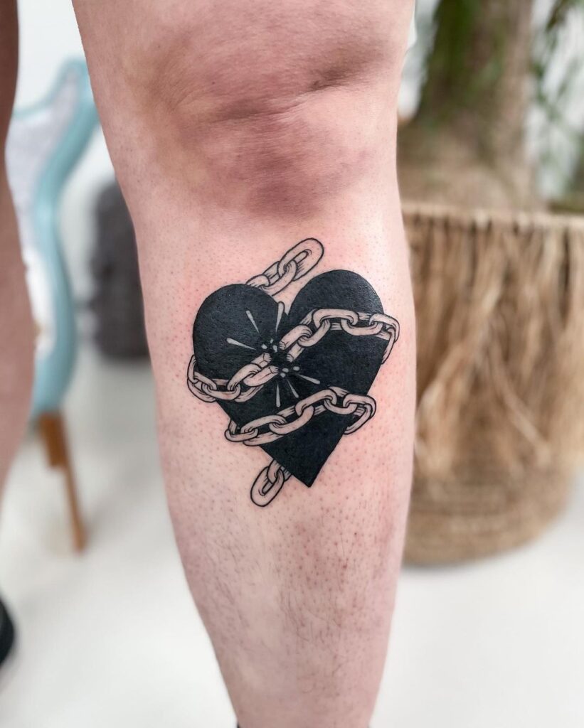 Sad love heart tattoo below the knee broken chains and emotions