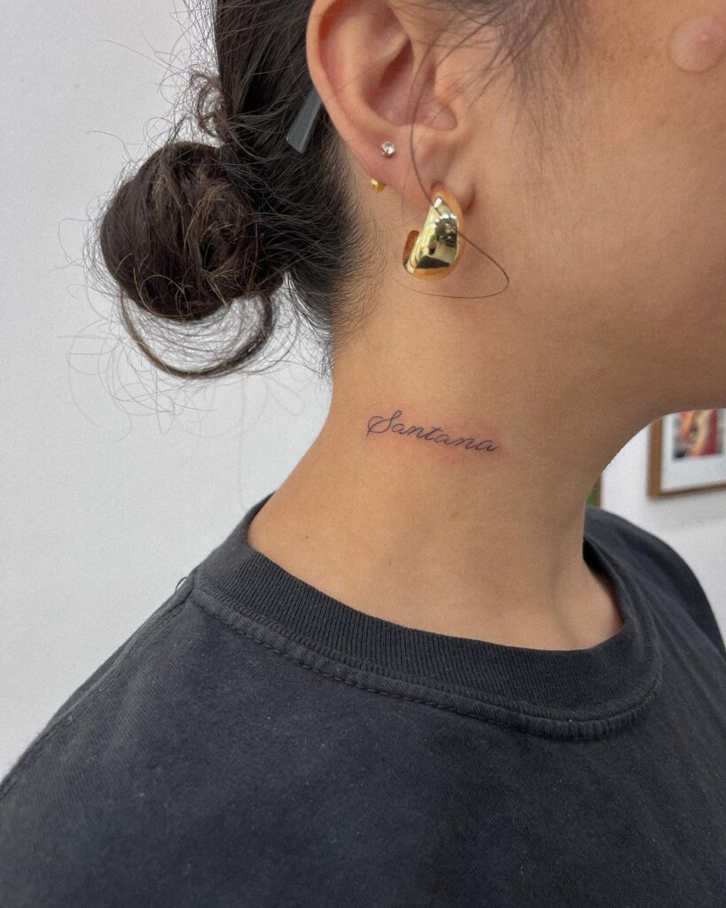 Santanas stylish flair italic word tattoo on the side of a girls neck