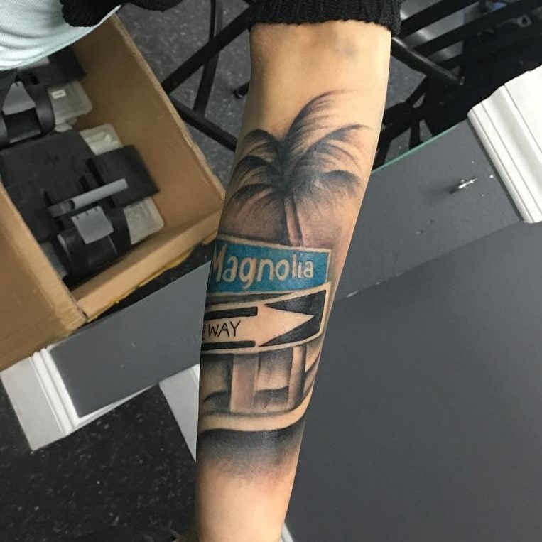 Seaside street sign tattoos on hand for men
