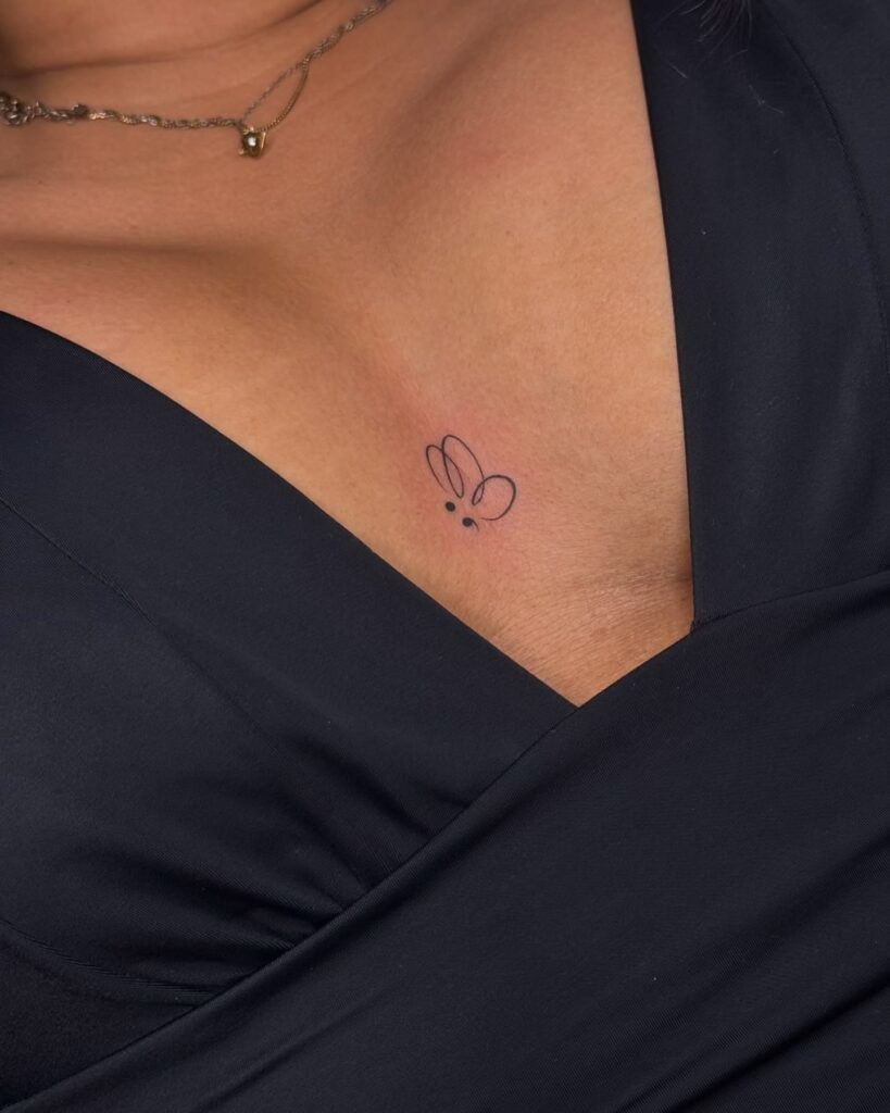 Semicolon butterfly sternum tattoo with deep personal meaning