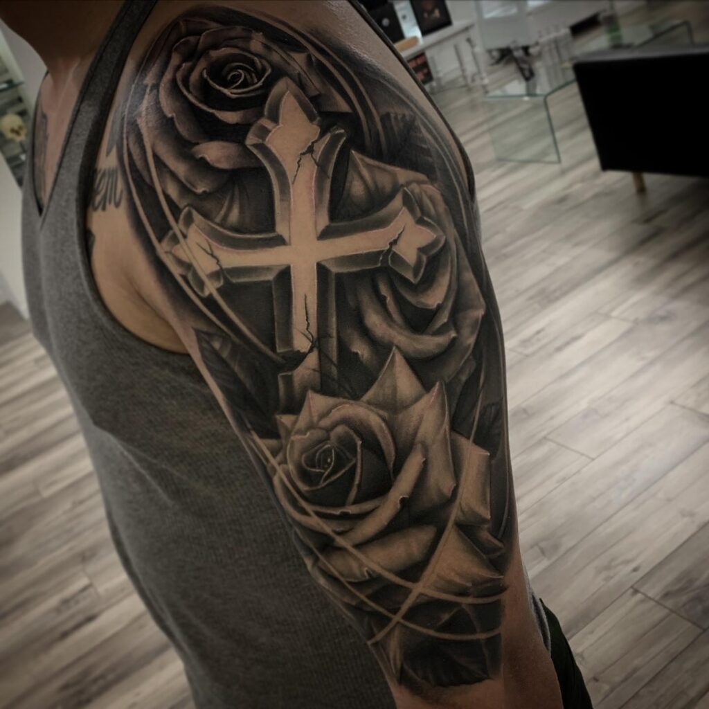 Shaded cross and roses tattoo for biceps design for men