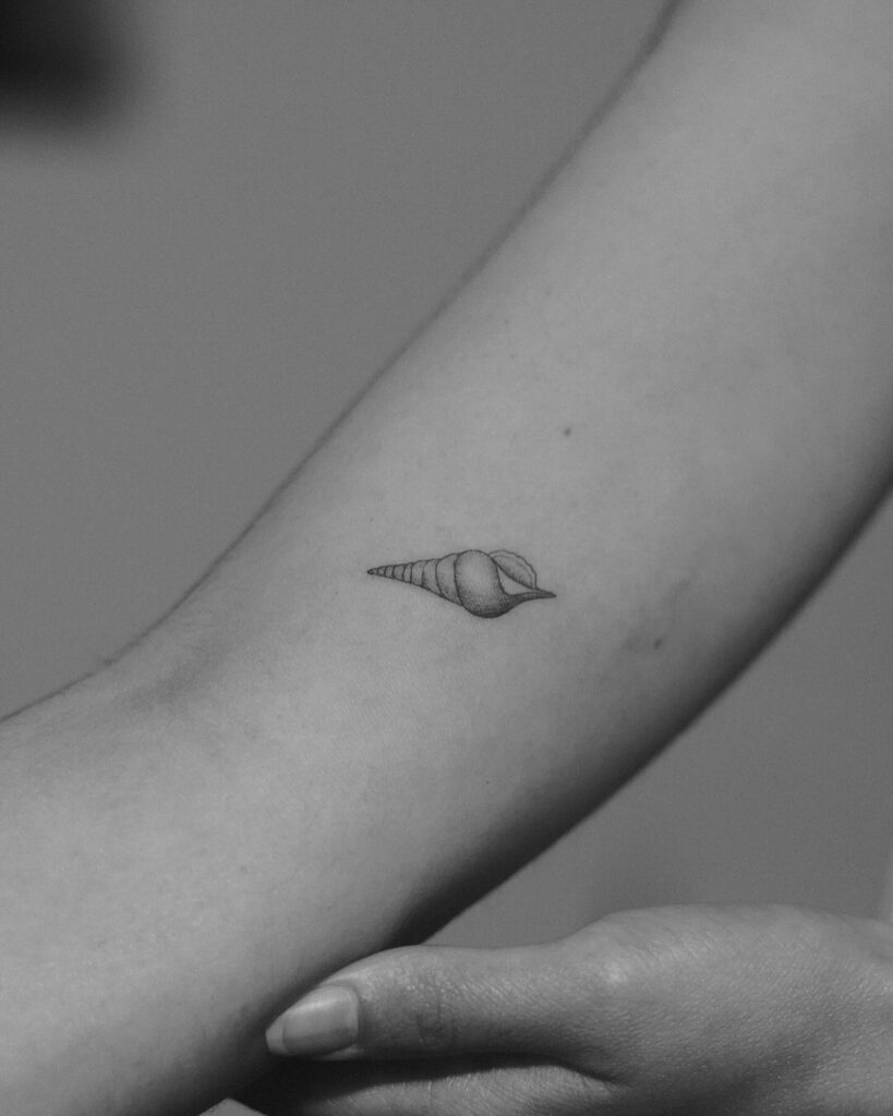 Shankha tattoo above the elbow an uniquely artistic expression conch shell serenity