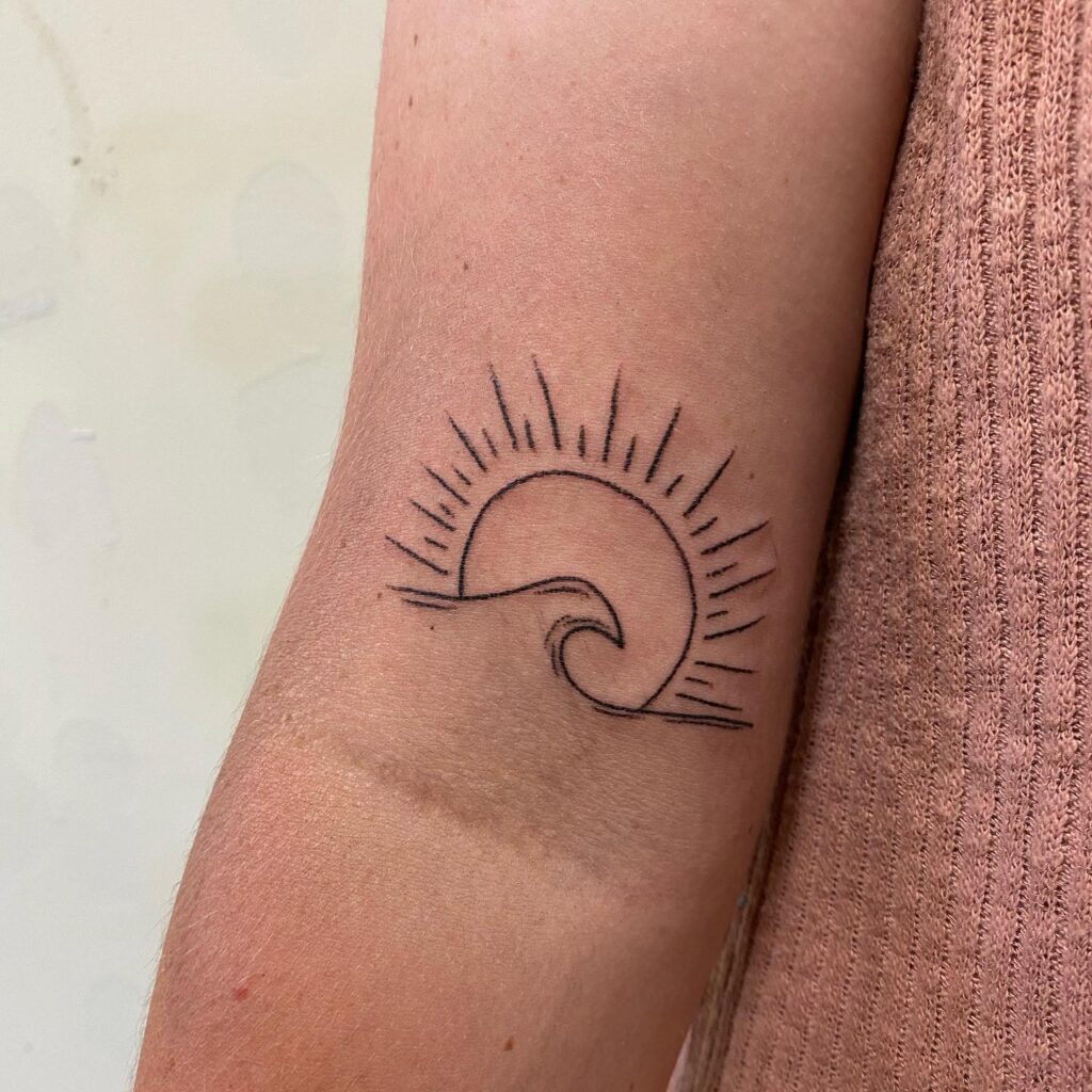 Shining Sun and Wave Tattoo on the Arm