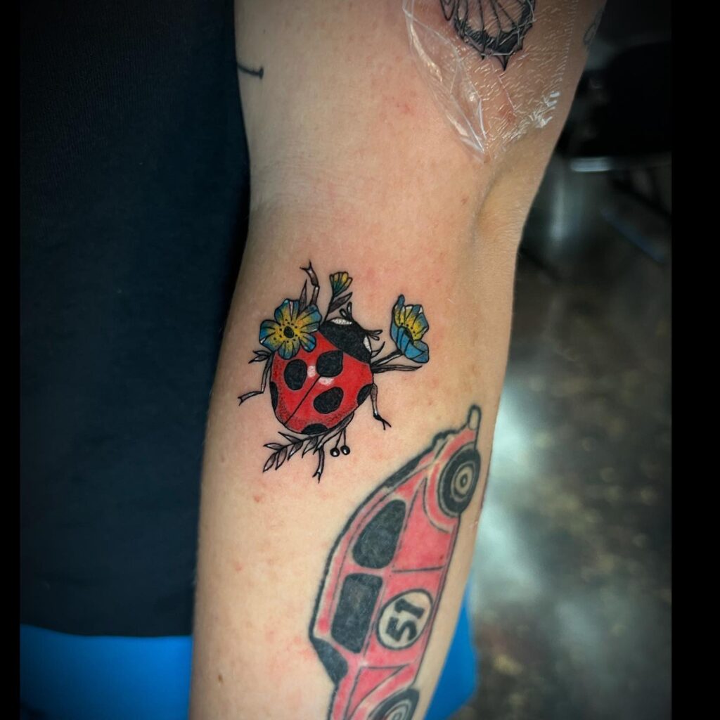 Shiny Lady Bug Tattoo Ideas With Colorful Flower