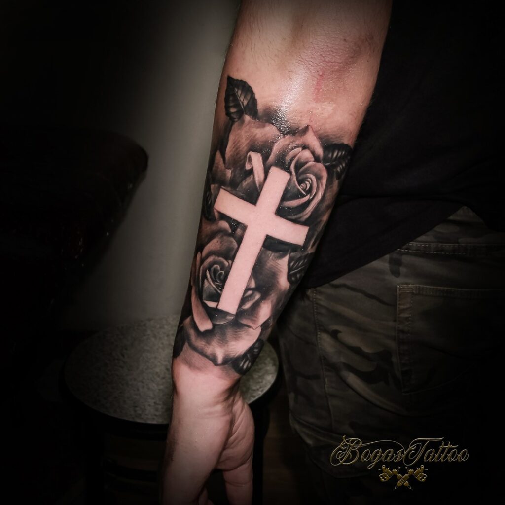 Side forearm roses with cross tattoo a stylish symbol of love and belief