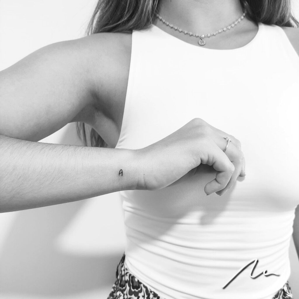 Side Mini 'A' Letter Tattoo: Wrist Elegance