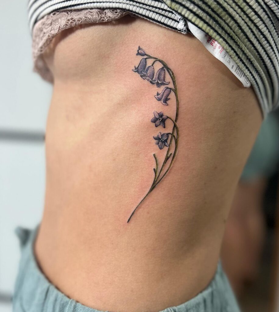 Side rib bluebell tattoo ideas with color feminine and artistic