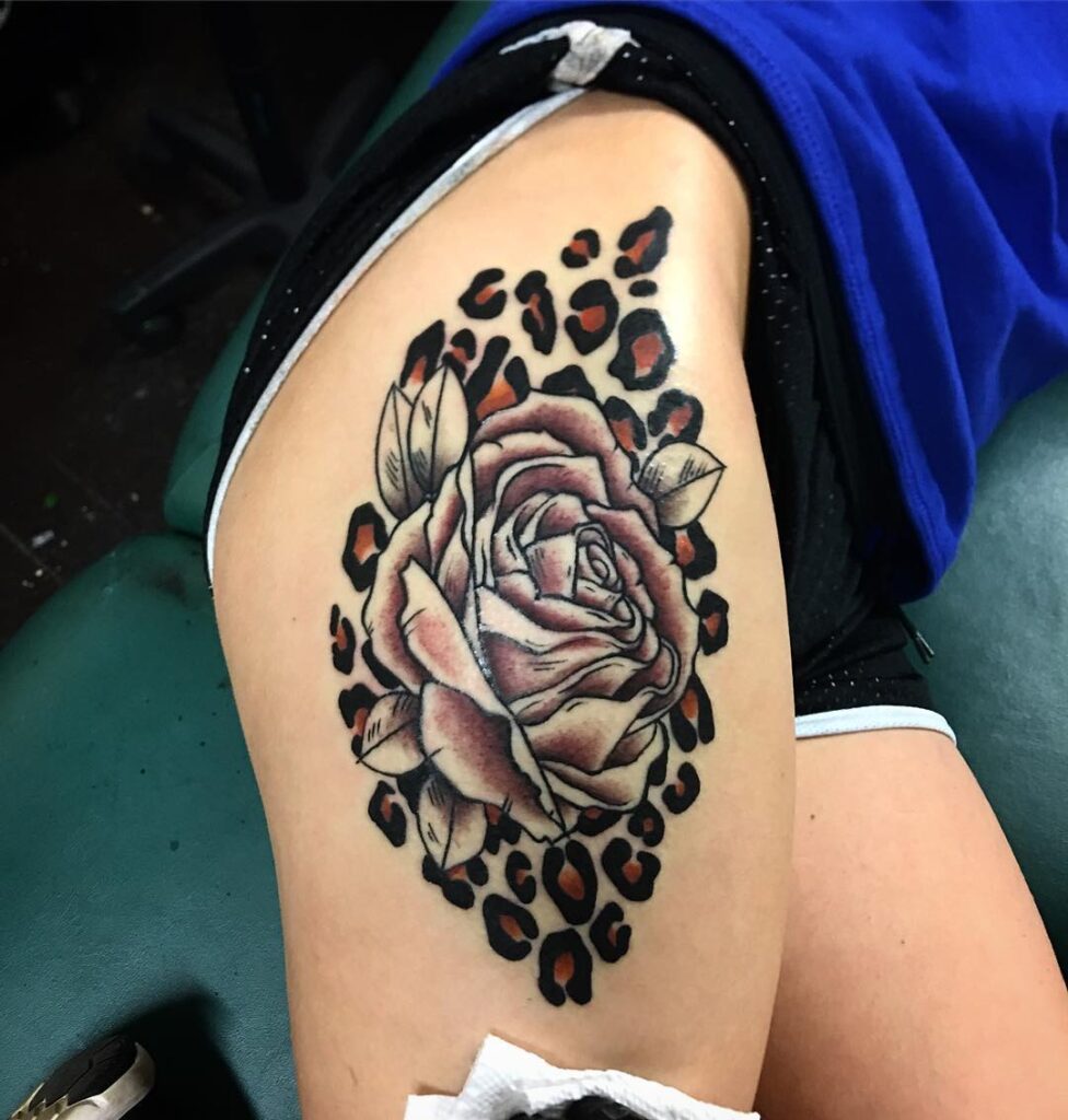 Side thigh leopard rose tattoo for females grace meets wilderness