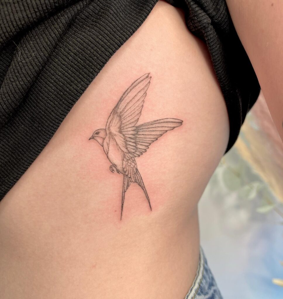 Side View Black and Grey Swallow Tattoo on the Rib: Winged Soar