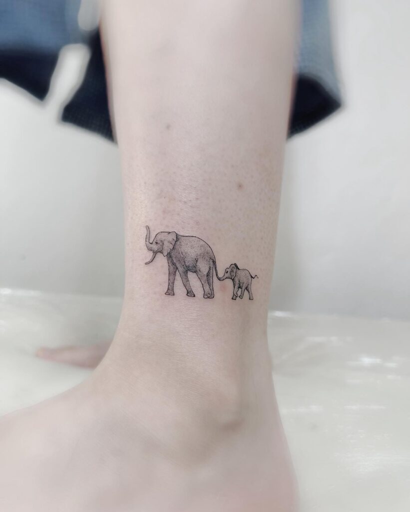 Side View Elephant and Baby Tattoo, Small Elephant Following, Holding Tail Through Trunk: Ankle Adventure