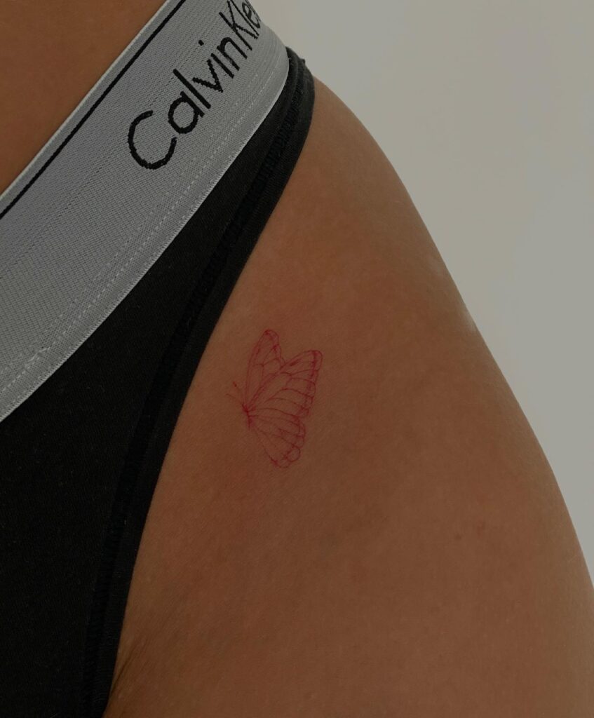 Side View Red Fineline Butterfly Tattoo on the Hip, a Graceful Splash of Color: Fiery Flutter