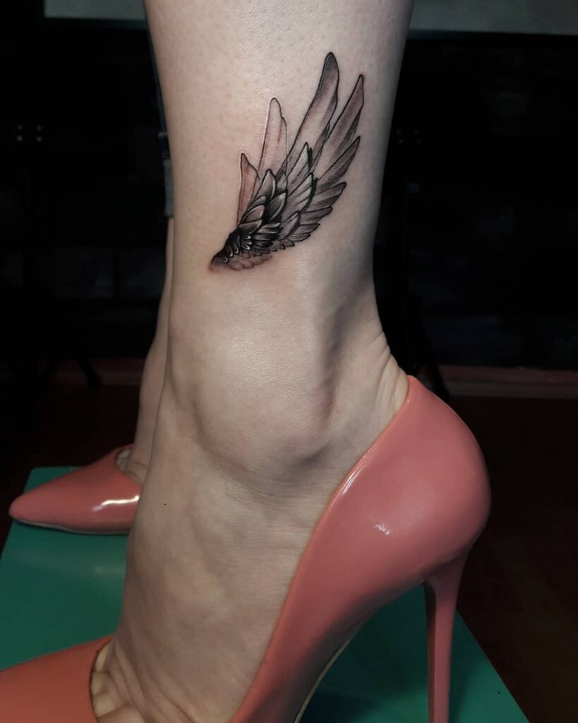 Side View Wing Tattoo Above the Ankle in Blackwork Ink: Stepping into Flight
