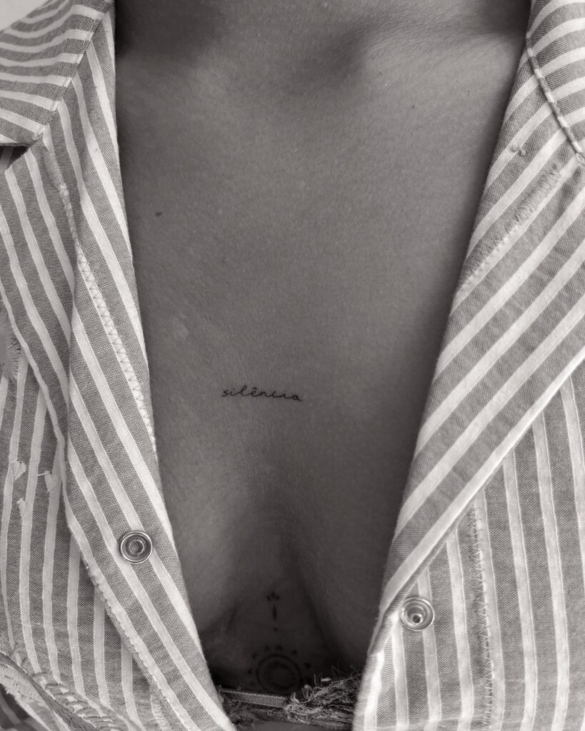 "Silêncio" script sternum tattoo with deep personal and symbolic meaning