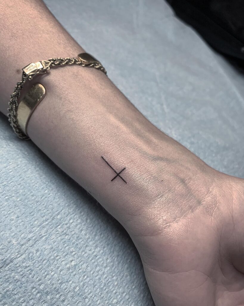 Simple Cross Tattoo Designs on Wrist for Female Minimalist Style