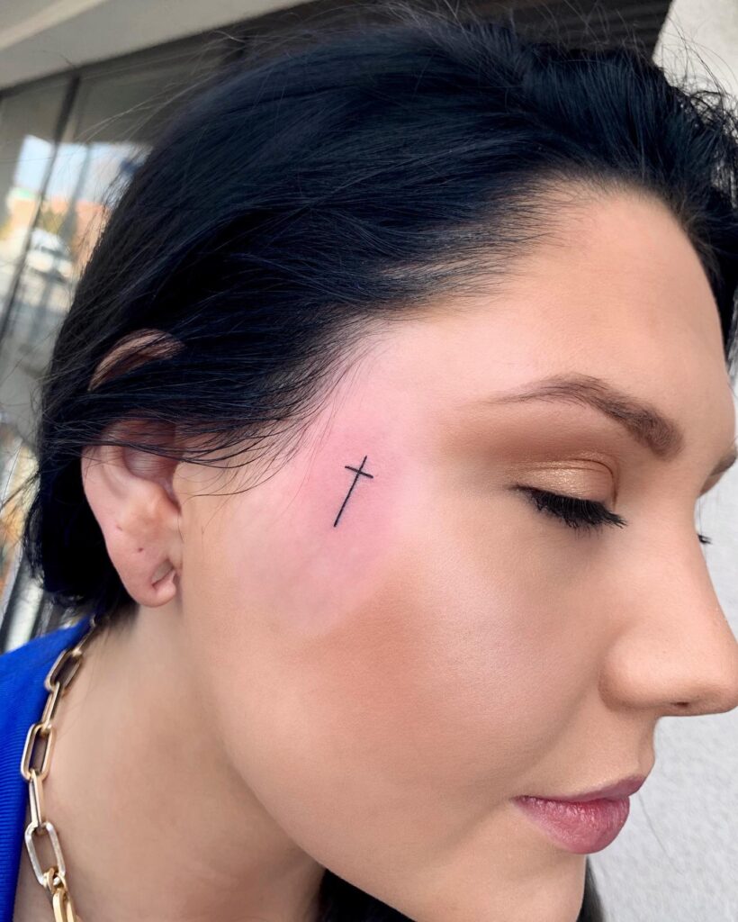 Simple Cross Tattoo on Face for Women Unique Expression