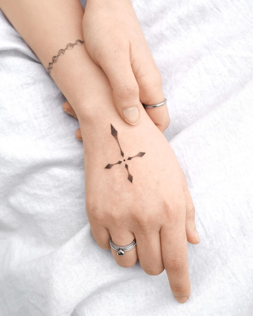 Simple Cross Tattoo on Girl's Back Hand Understated Beauty