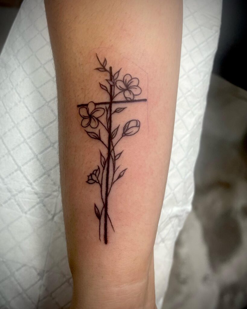 Simple Cross Tattoo with Flowers A Beautiful Blend of Faith and Nature on Your Hand