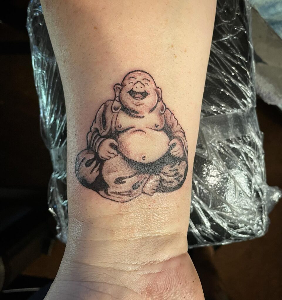Simple Laughing Buddha Wrist Tattoo Subtle Reminder of Happiness 