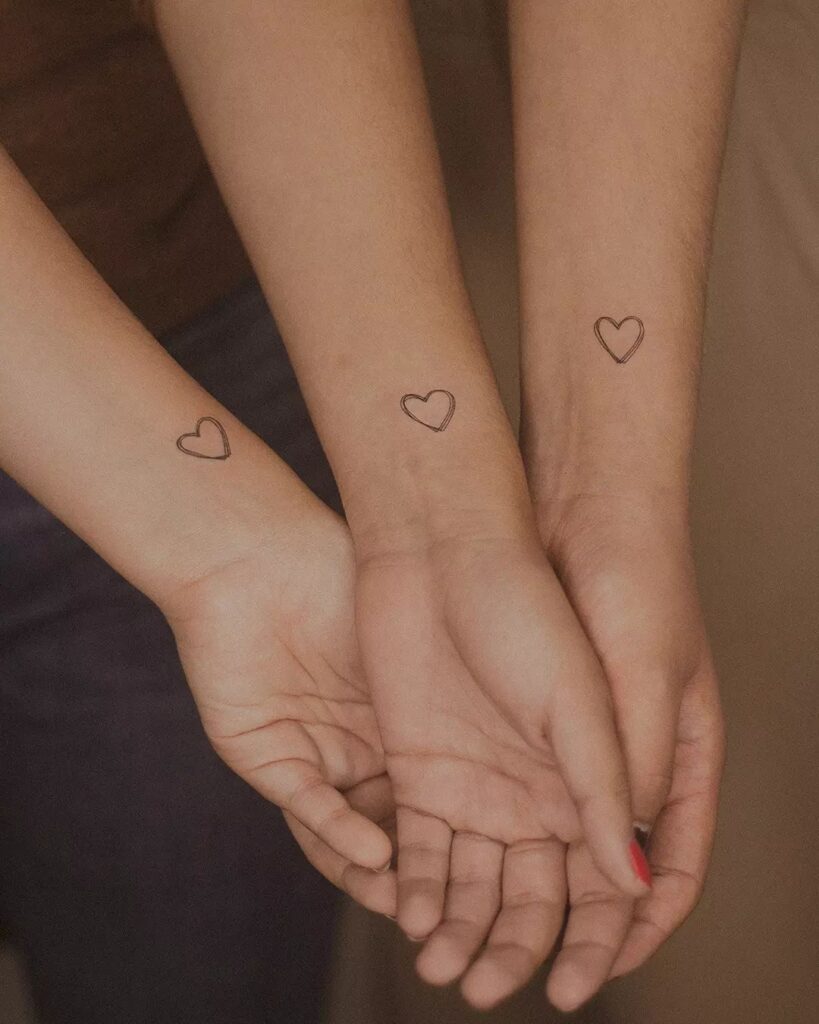 Simple Small Double Outline Thin Heart Shaped Tattoo on the Side of the Inner Wrist, A Symbol of Friendship and Unity: Triplet Unity