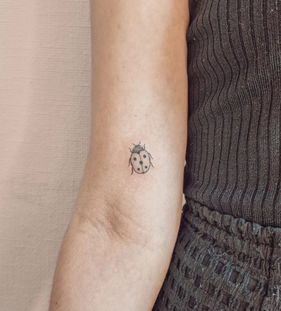 Simple Small Ladybug Tattoo Above the Elbow Design