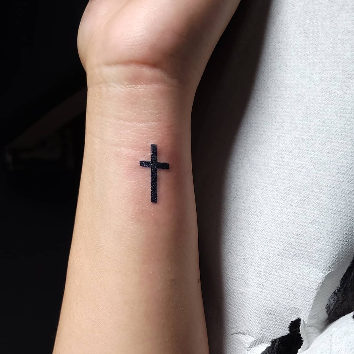 Simple Black Cross Wrist Tattoo Faith and Spiritual Devotion Symbol