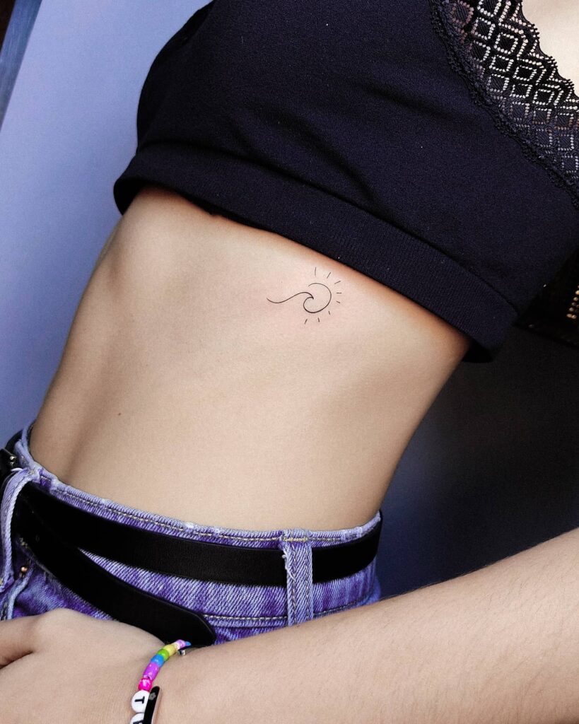 Simple deep meaning wave and sun side breast tattoo symbolism and beauty combined
