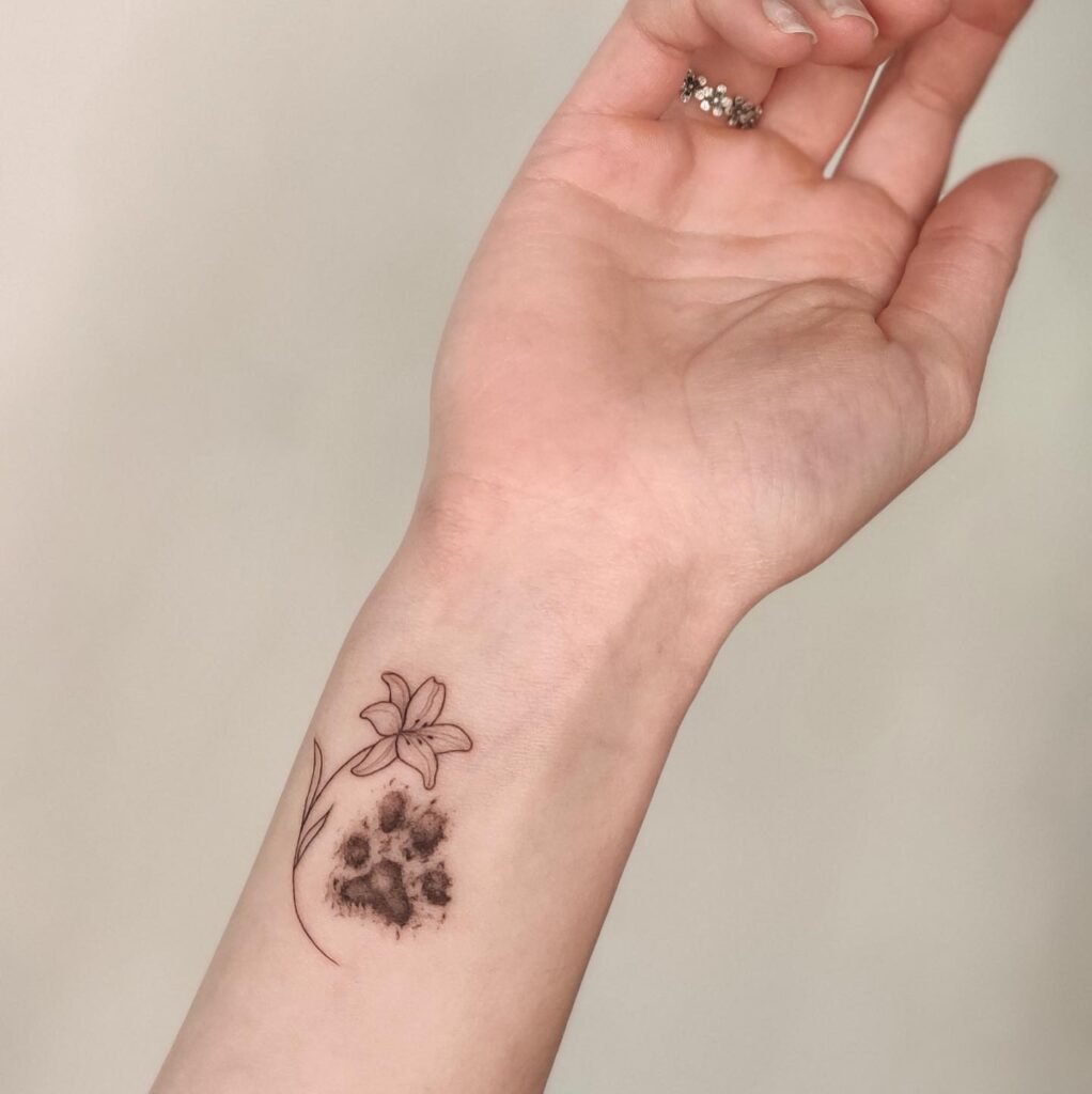 Simple Dog Paw Tattoo with a Delicate Flower on the Inner Wrist: Whimsical Wrist