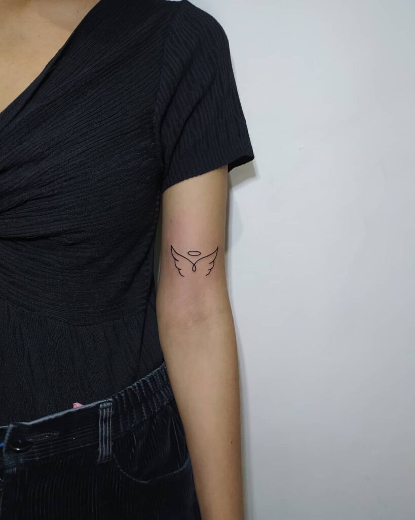 Simple Fineline Angel Wings Tattoo Above the Elbow: Serenity Lines