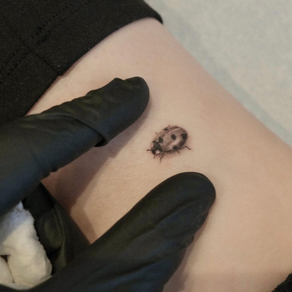 Simple Girl Above the Ankle Ladybug Tattoo: Minimalist and Elegant Design