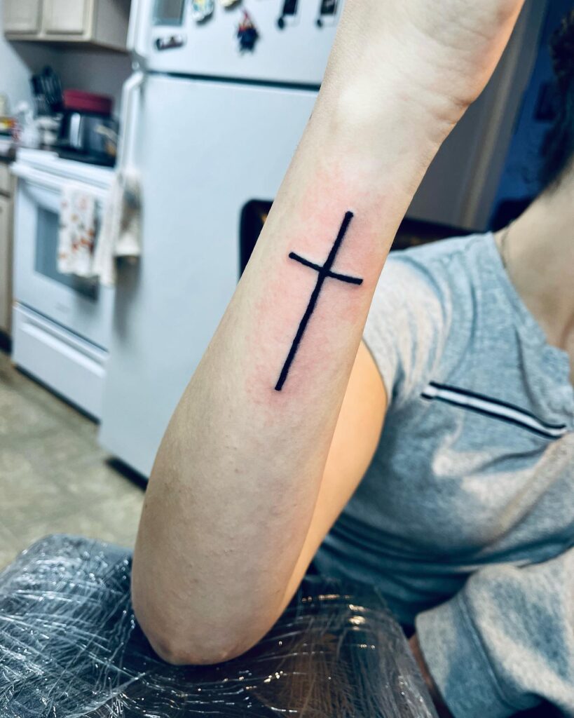 Simple outer forearm cross tattoo female ideas