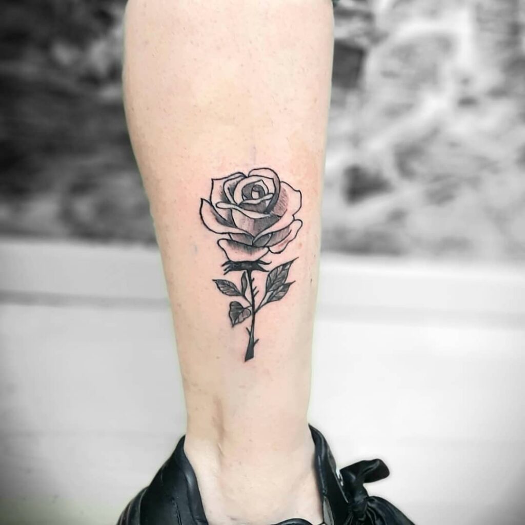 Simple single rose tattoo leg