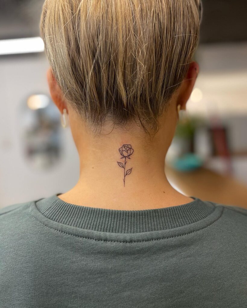 Simplicity in symbolism outline rose tattoo gracing the back of the neck