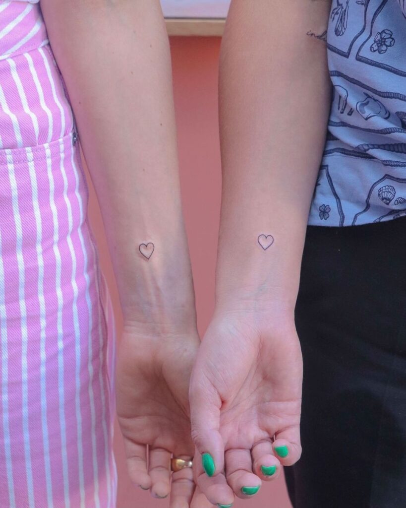 Sisterly love discover matching outline heart wrist tattoos for a special bond