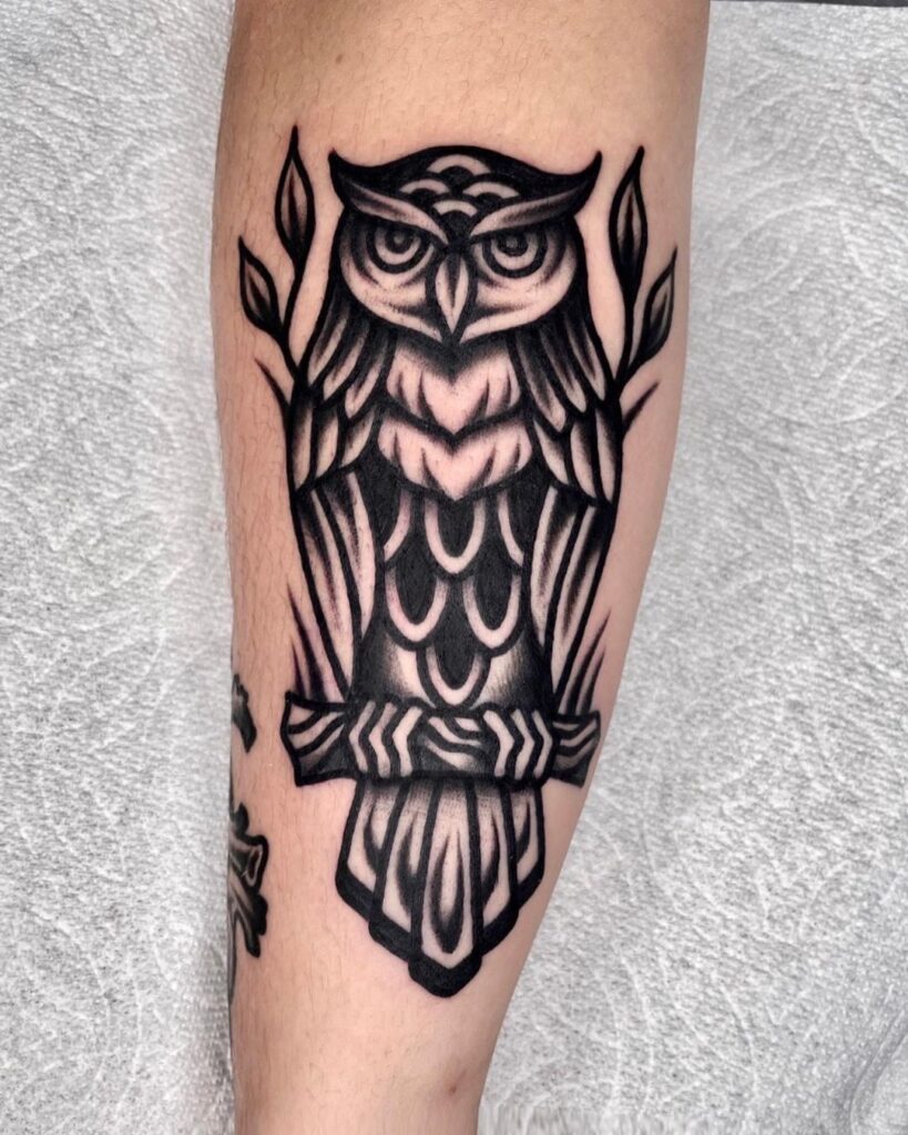 Sitting owl on branch forearm blackwork tattoo
