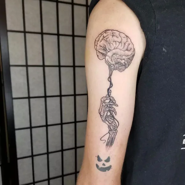 Skeleton hand tattoo on arm