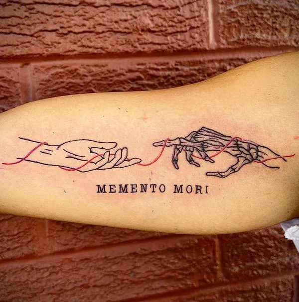 Skeleton hand tattoo on bicep