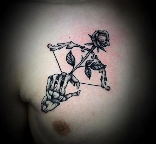 Skeleton hand tattoo on chest