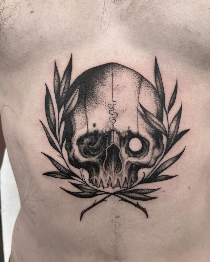 Skull and leaves blackwork tattoo stomach design for men
