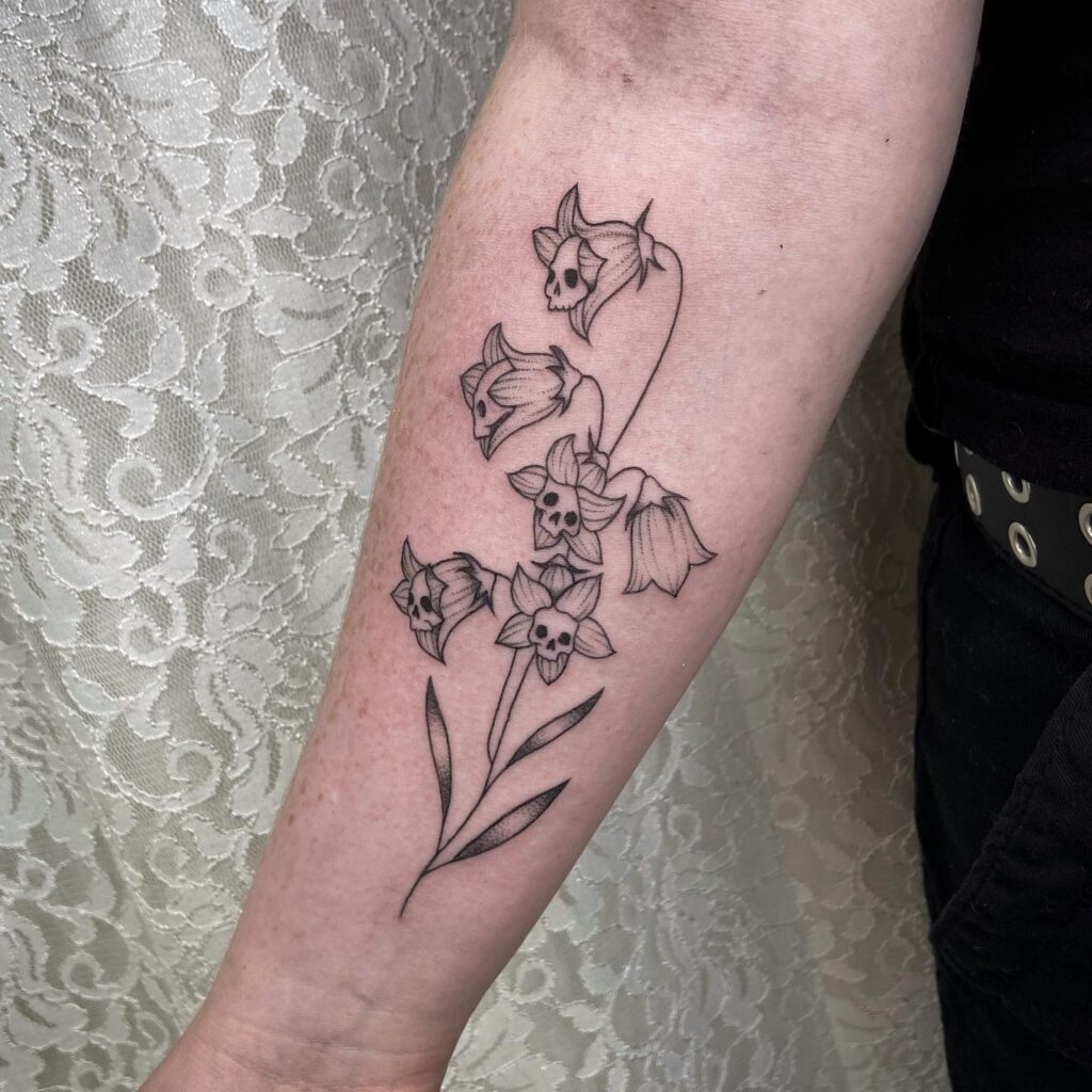 Skull flowers bluebell tattoo on wrist a unique design