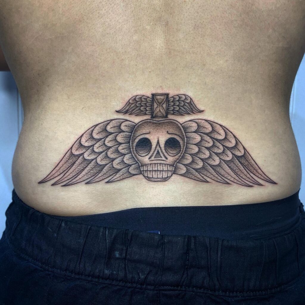 Skull Head with Wings Tattoo, a Symbolic Artistry on the Lower Back: Eternal Passage