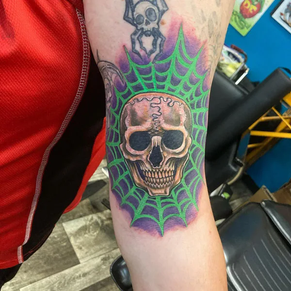 Skull spider web tattoo