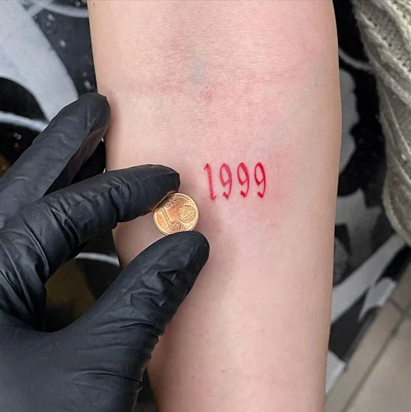 Small 1999 tattoo