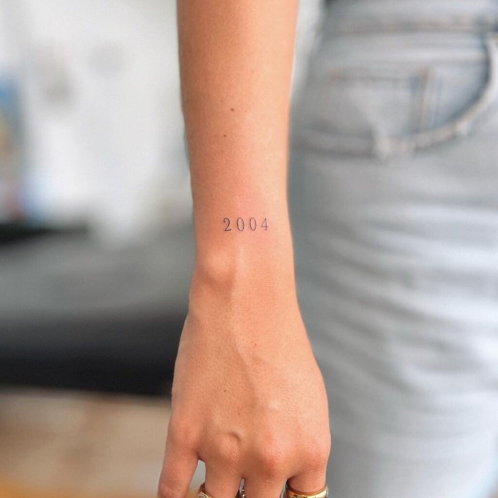 Small 2004 tattoo on outer wrist a memorable year inked