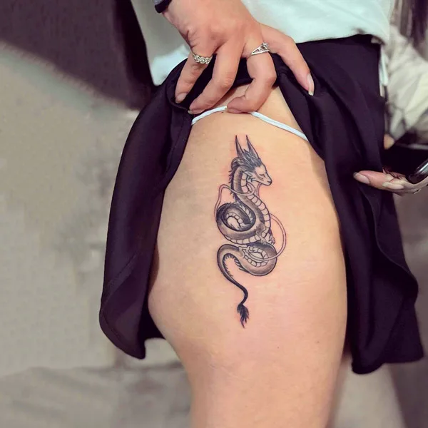 Small Dragon tattoo on thigh
