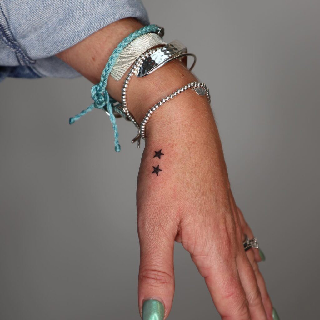 Small Two Stars on the Hand, Minimalist and Filled with Black Color: Stellar Pair