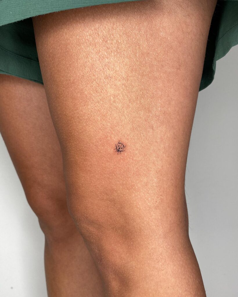 Small Above the Knee Tattoos: Ladybug Tattoo for Feminine Accent